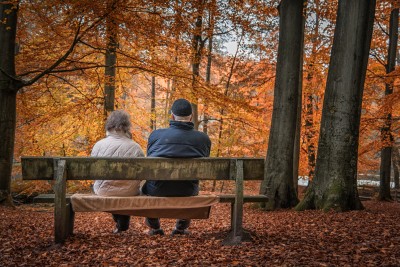 Pensioners on bench in woods